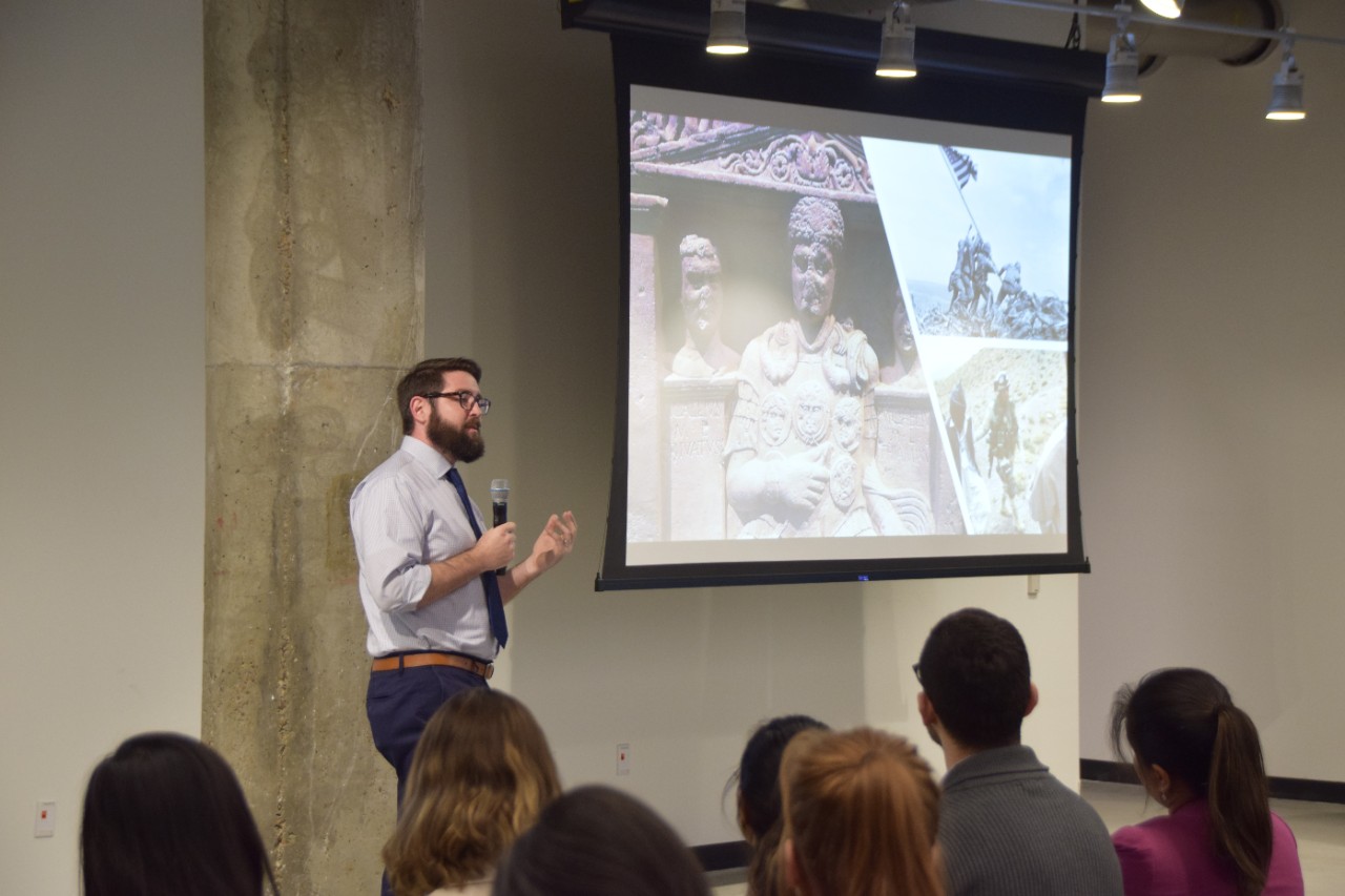 A graduate student presents his research at the Three Minute Thesis competition. 